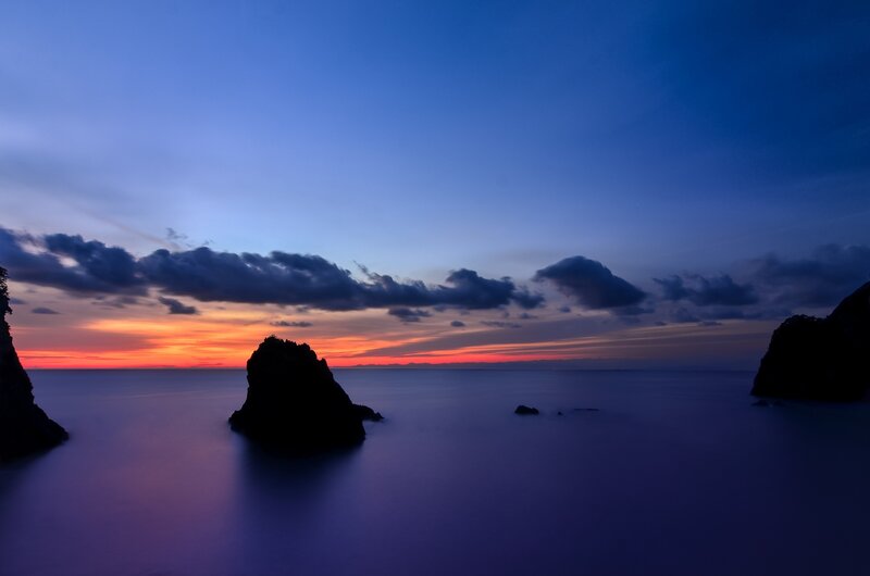 Silhouetted Rocks at Sunset — Blue, Serene, Photograph, Ocean