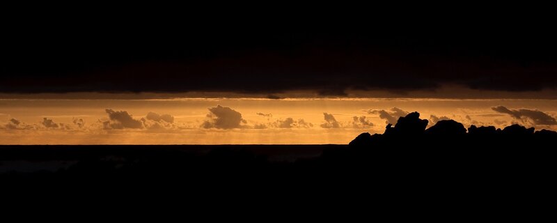 Silhouetted Rocks at Sunset — Orange, Dramatic, Photograph, Clouds