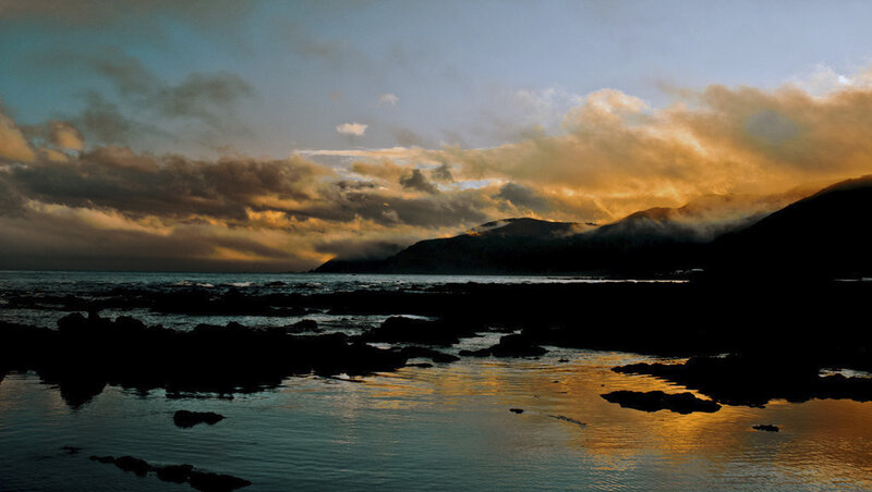 Silhouetted Rocks at Sunset — Orange, Dramatic, Photograph