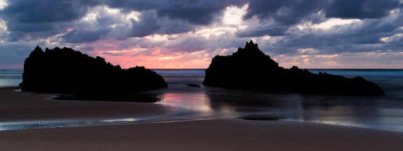 Silhouetted Rocks at Sunset — Purple, Dramatic