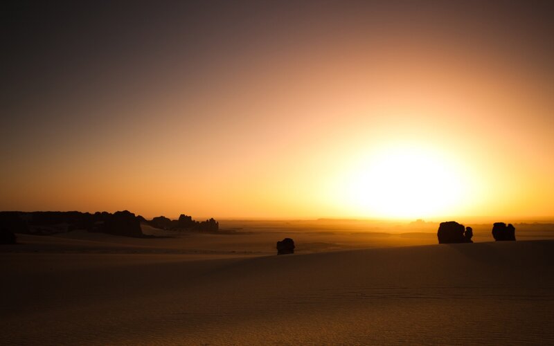 Silhouetted Rocks in Desert — Orange