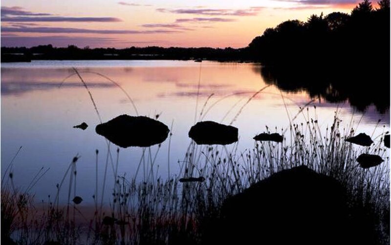 Silhouetted Rocks in Lake — Purple