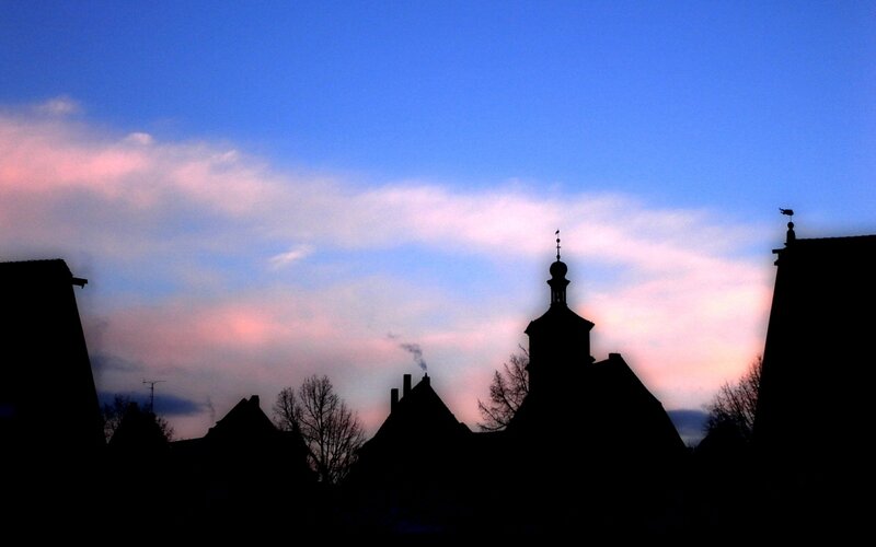 silhouetted rooftops at dusk