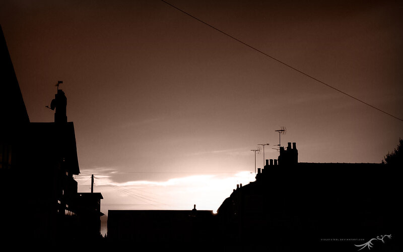 silhouetted rooftops at dusk