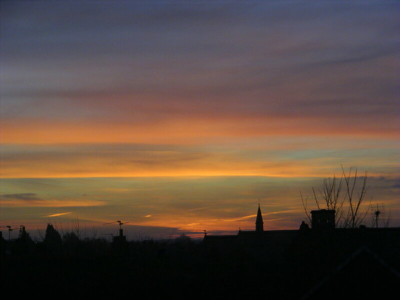 Silhouetted Rooftops at Sunset — Orange