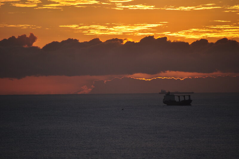 Silhouetted Ships at Sea