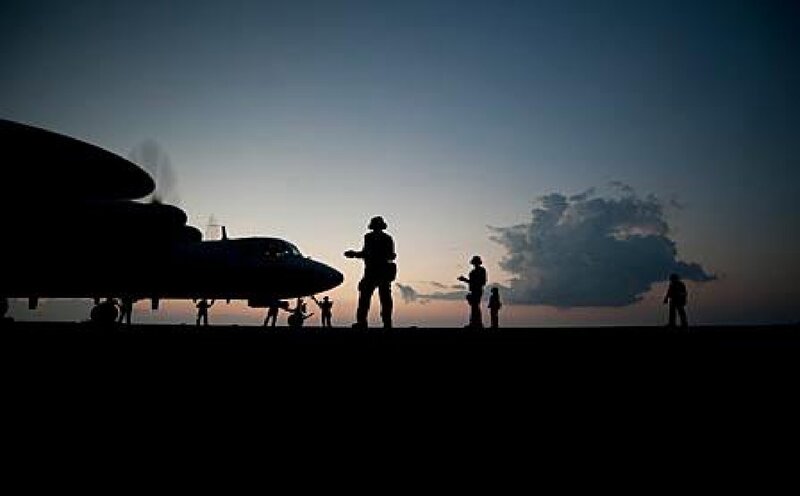 Silhouetted Soldiers on Tarmac
