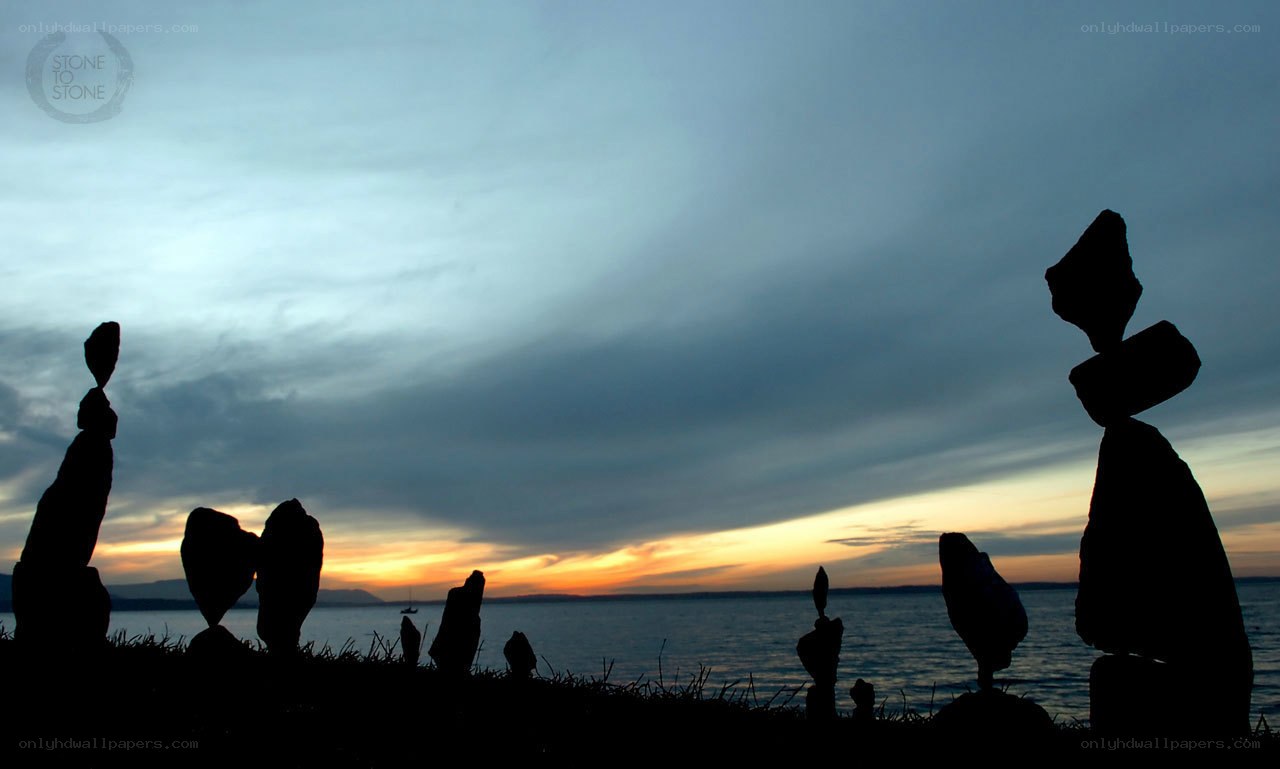 Silhouetted stone stacks at sunset