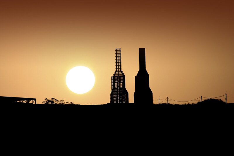 Silhouetted Towers at Sunset — Orange, Dramatic, Photograph