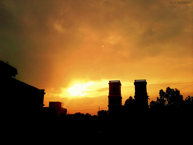 Silhouetted Towers at Sunset — Orange