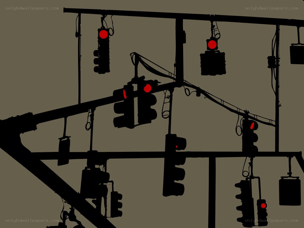 Silhouetted traffic lights at intersection