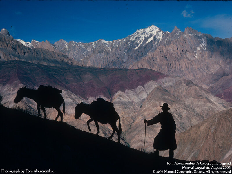 Silhouetted travelers in mountains