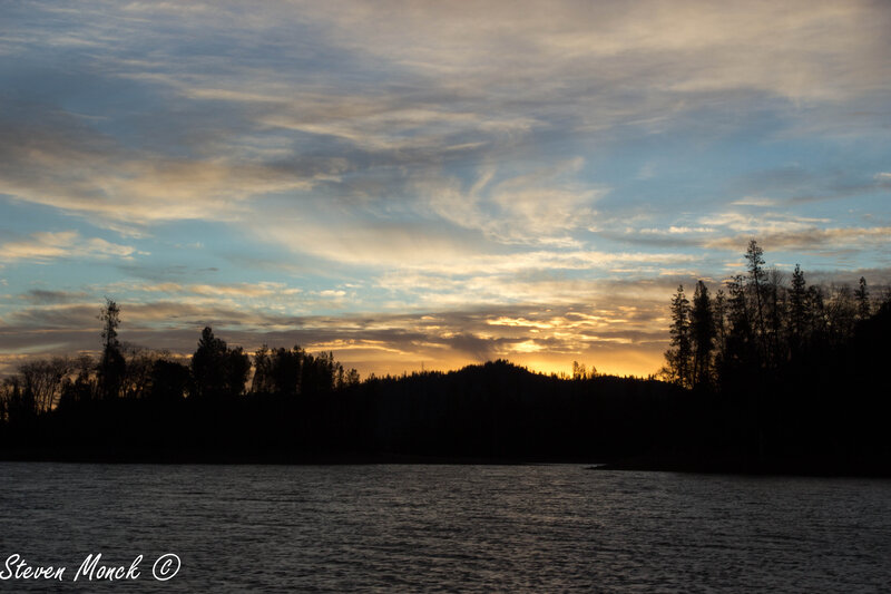 Silhouetted Trees at Sunset — Blue, Serene, Photograph, Sky, Clouds, River