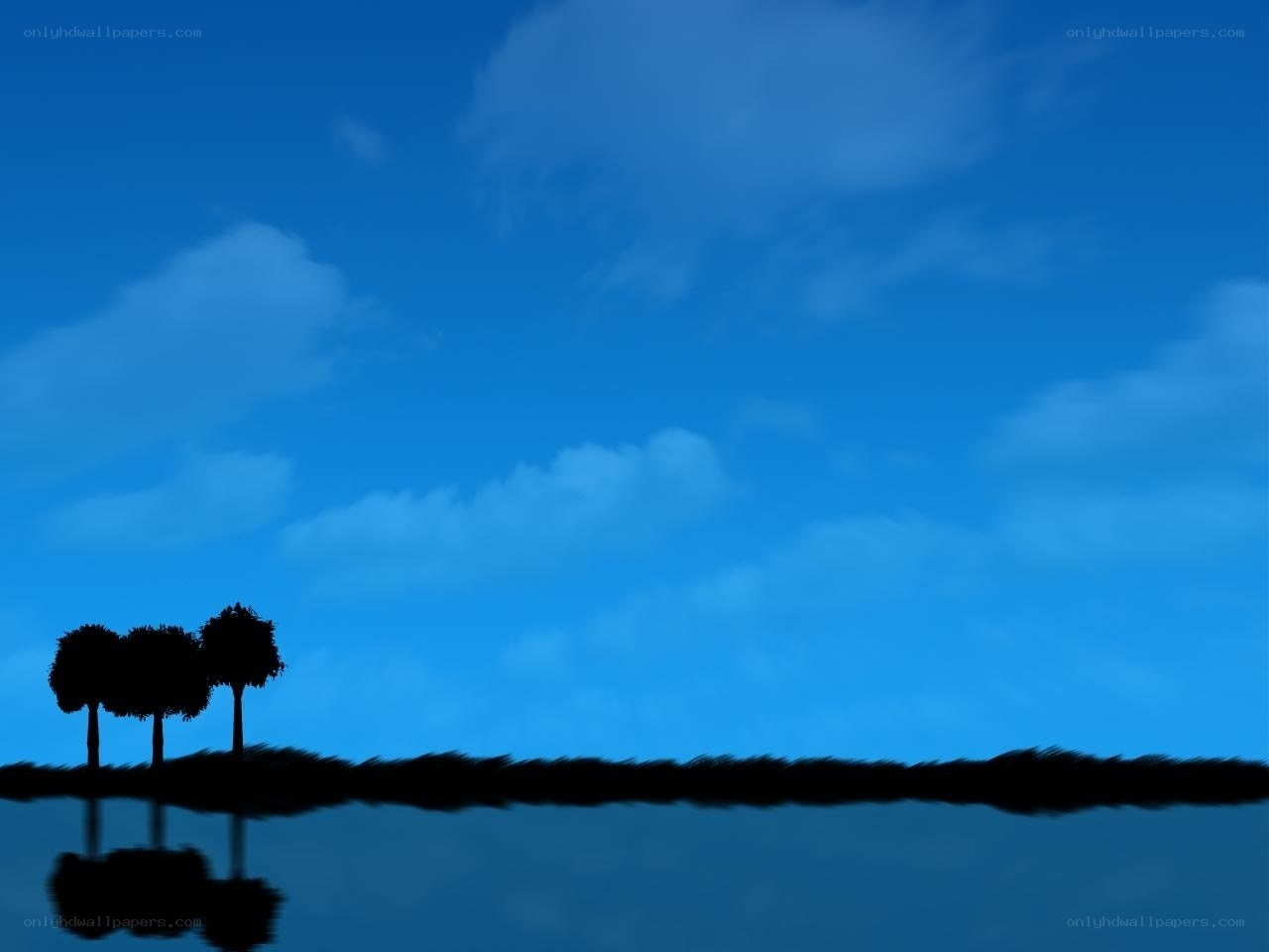 Silhouetted trees on a lake