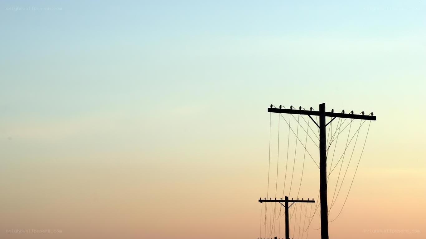 silhouetted utility poles at dusk