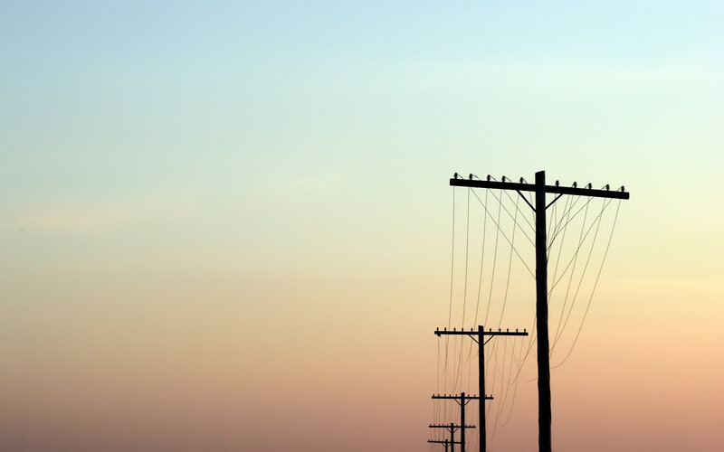 Silhouetted Utility Poles — Blue