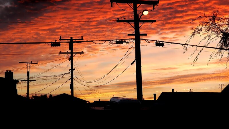 Silhouetted Utility Poles — Orange, Dramatic