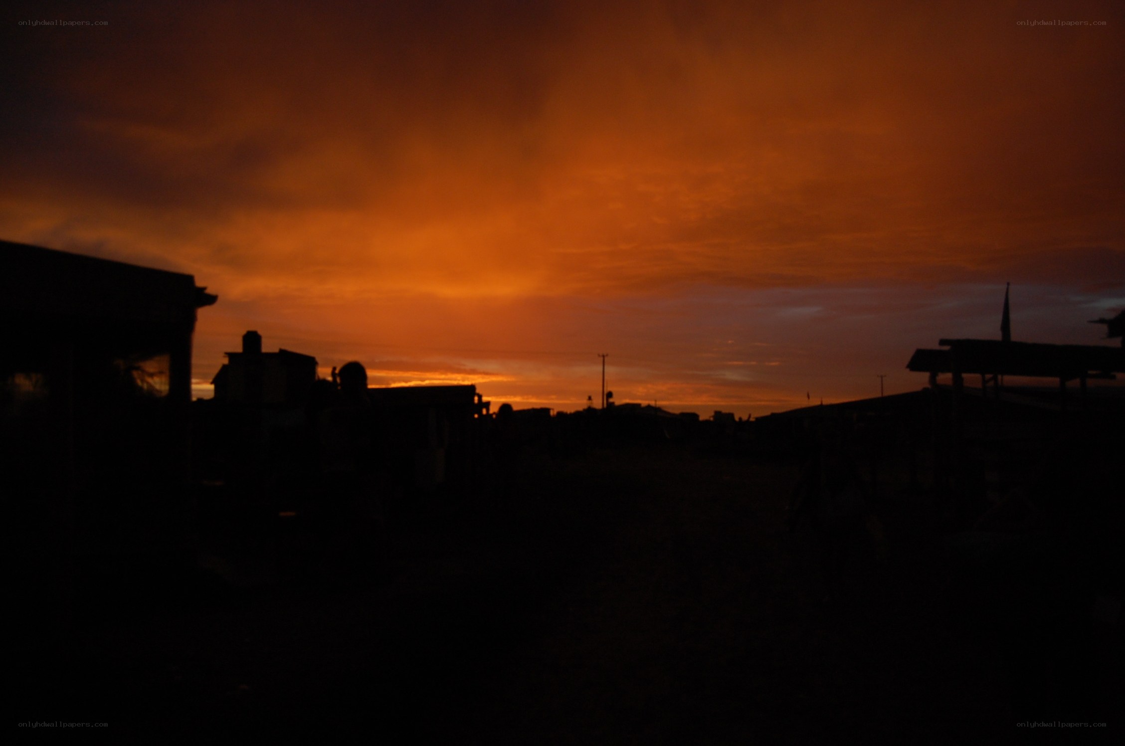 silhouetted village at sunset