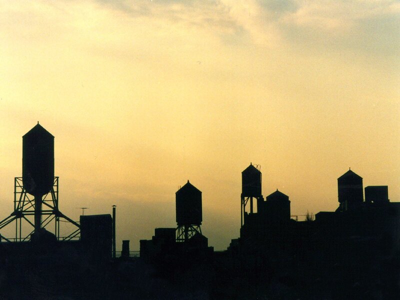 silhouetted water towers at dusk