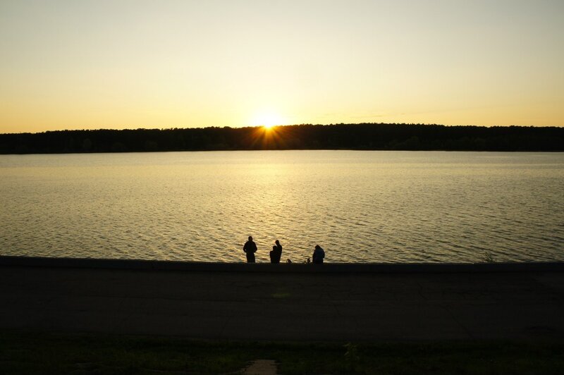 Silhouettes at sunset by the lake