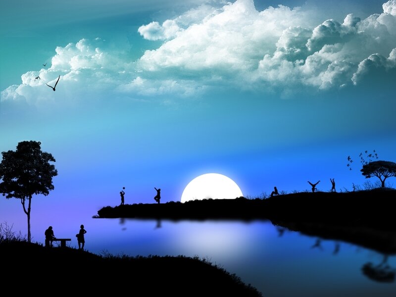 Silhouettes at sunset by the lake