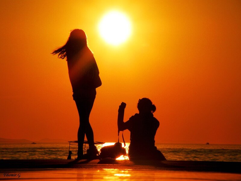 Silhouettes at sunset by the sea