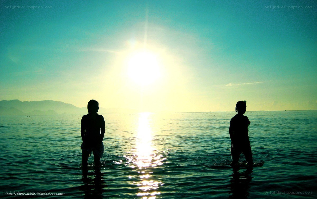 Silhouettes at sunset by the sea