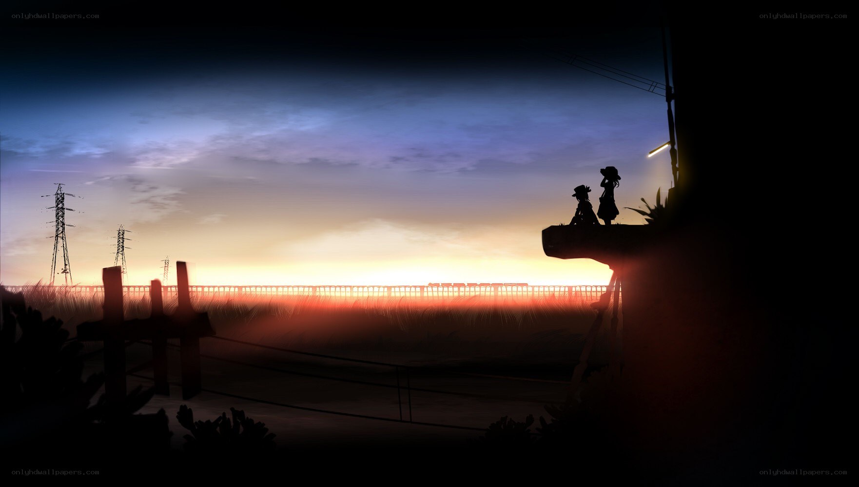 Silhouettes at sunset by the tracks