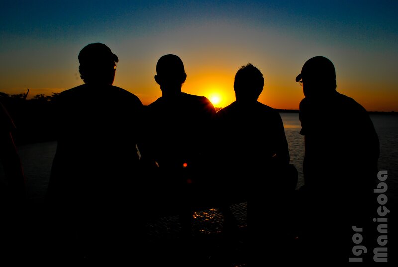 Silhouettes at sunset by the water