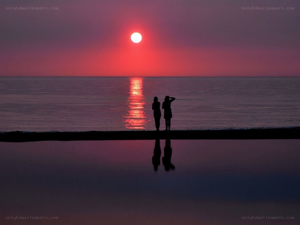 Silhouettes at sunset on the beach