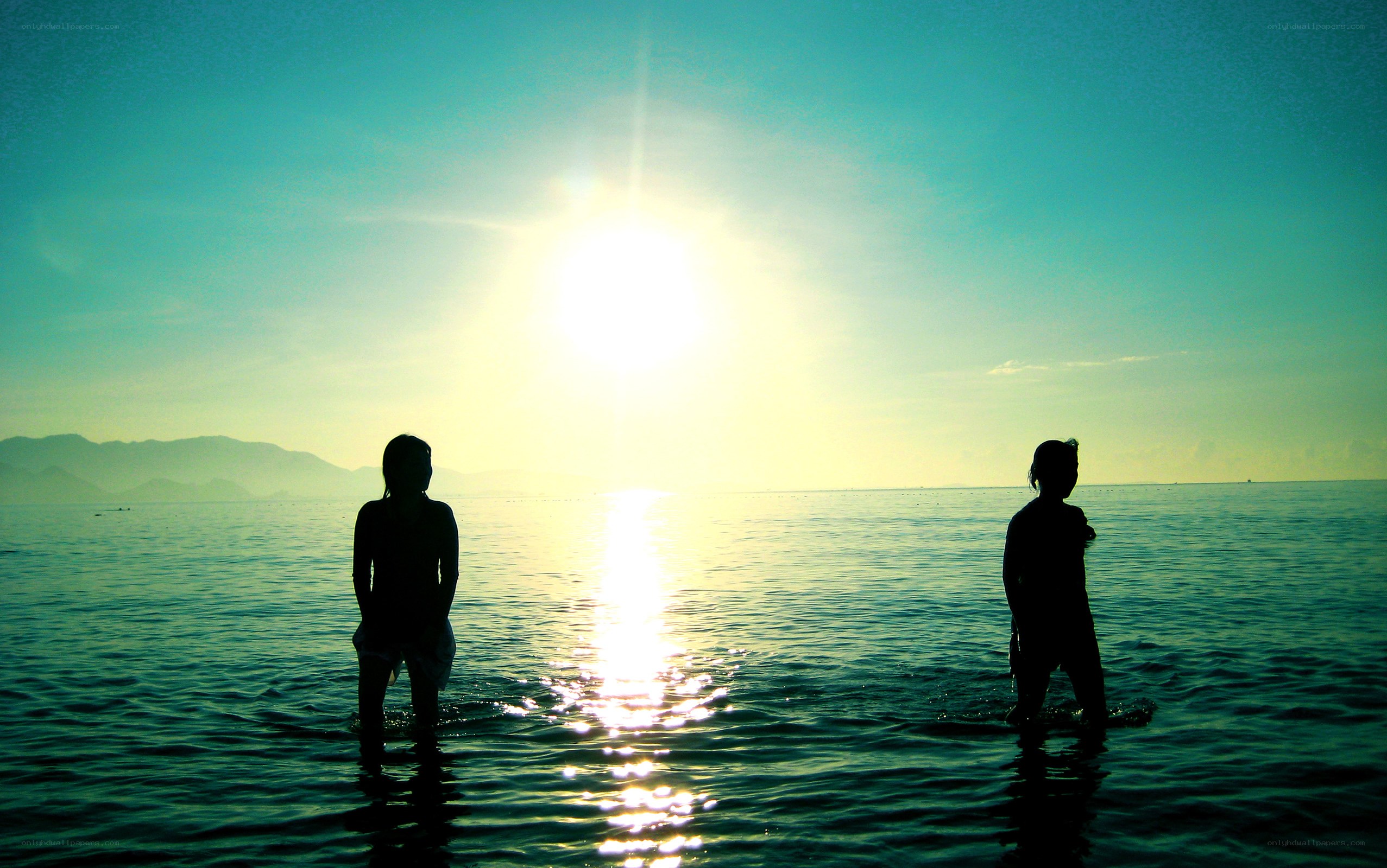 Silhouettes at sunset on the water