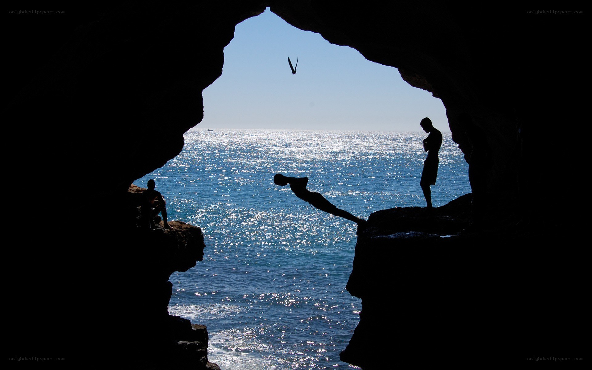 Silhouettes at the cave entrance
