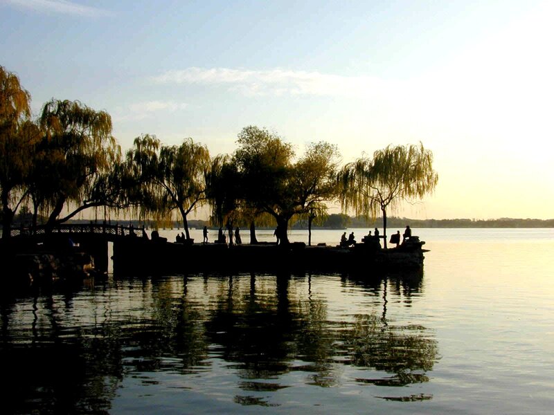 Silhouettes by the lake at sunset