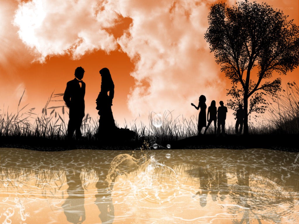 Silhouettes by the water at sunset