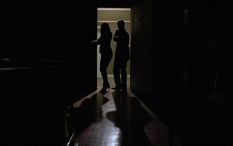 Silhouettes in a dark hallway