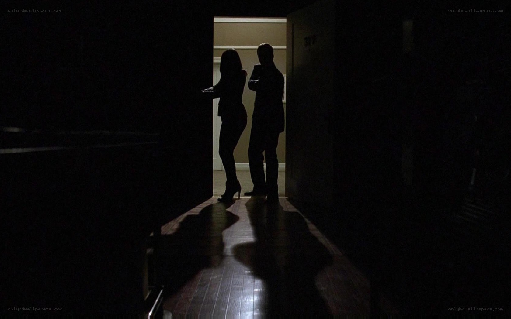 Silhouettes in a dark hallway