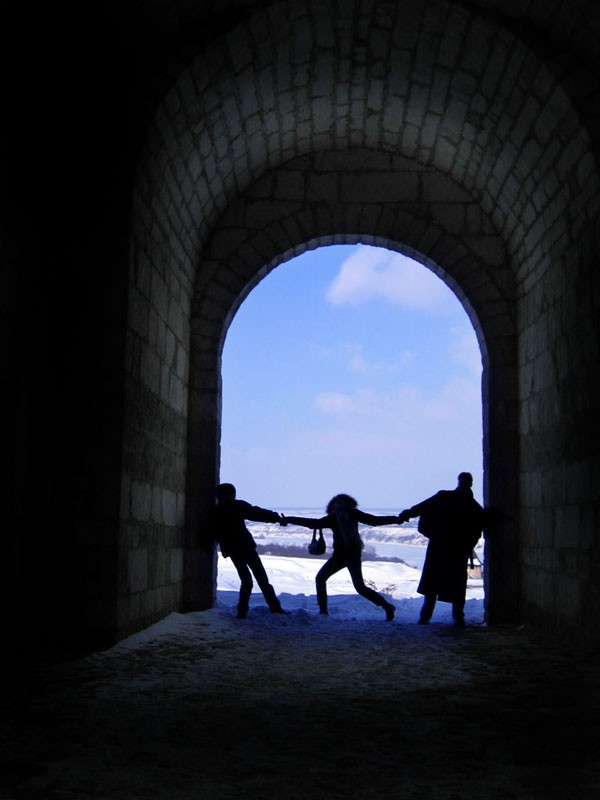 Silhouettes in a stone archway