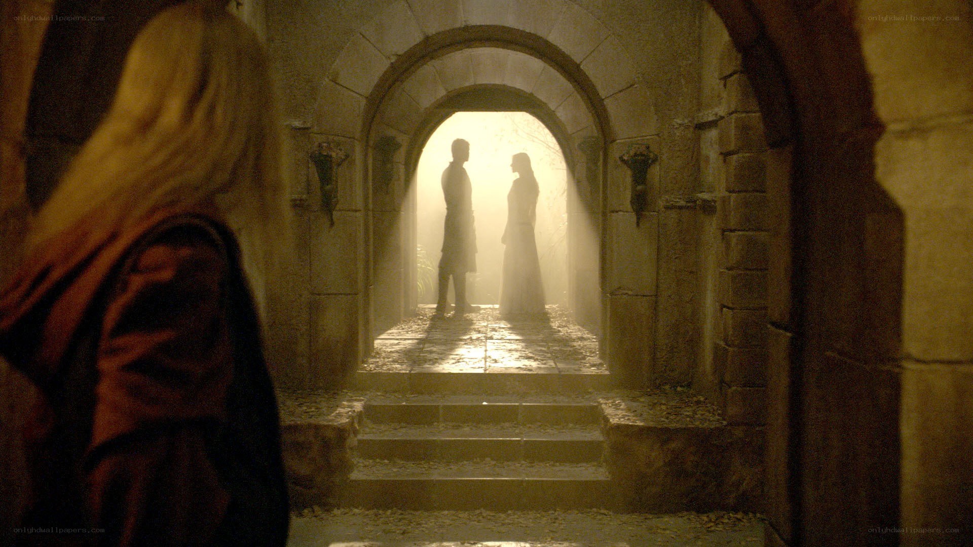 silhouettes in a stone corridor