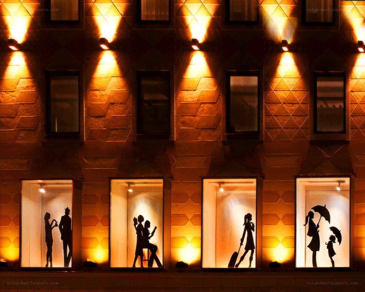 Silhouettes in illuminated windows