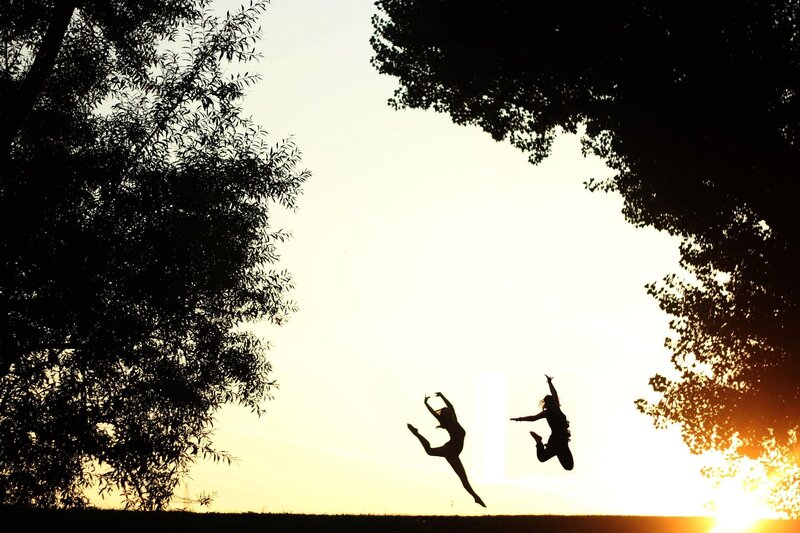 Silhouettes of dancers jumping