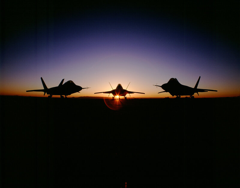 Silhouettes of fighter jets at sunset