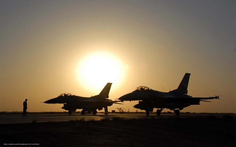 Silhouettes of fighter jets at sunset