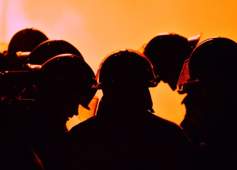 silhouettes of firefighters in action