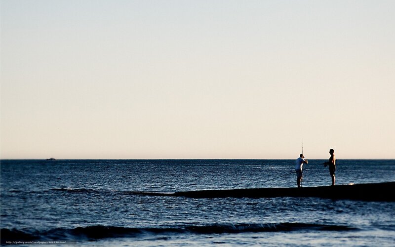 Silhouettes of fishermen at sunset