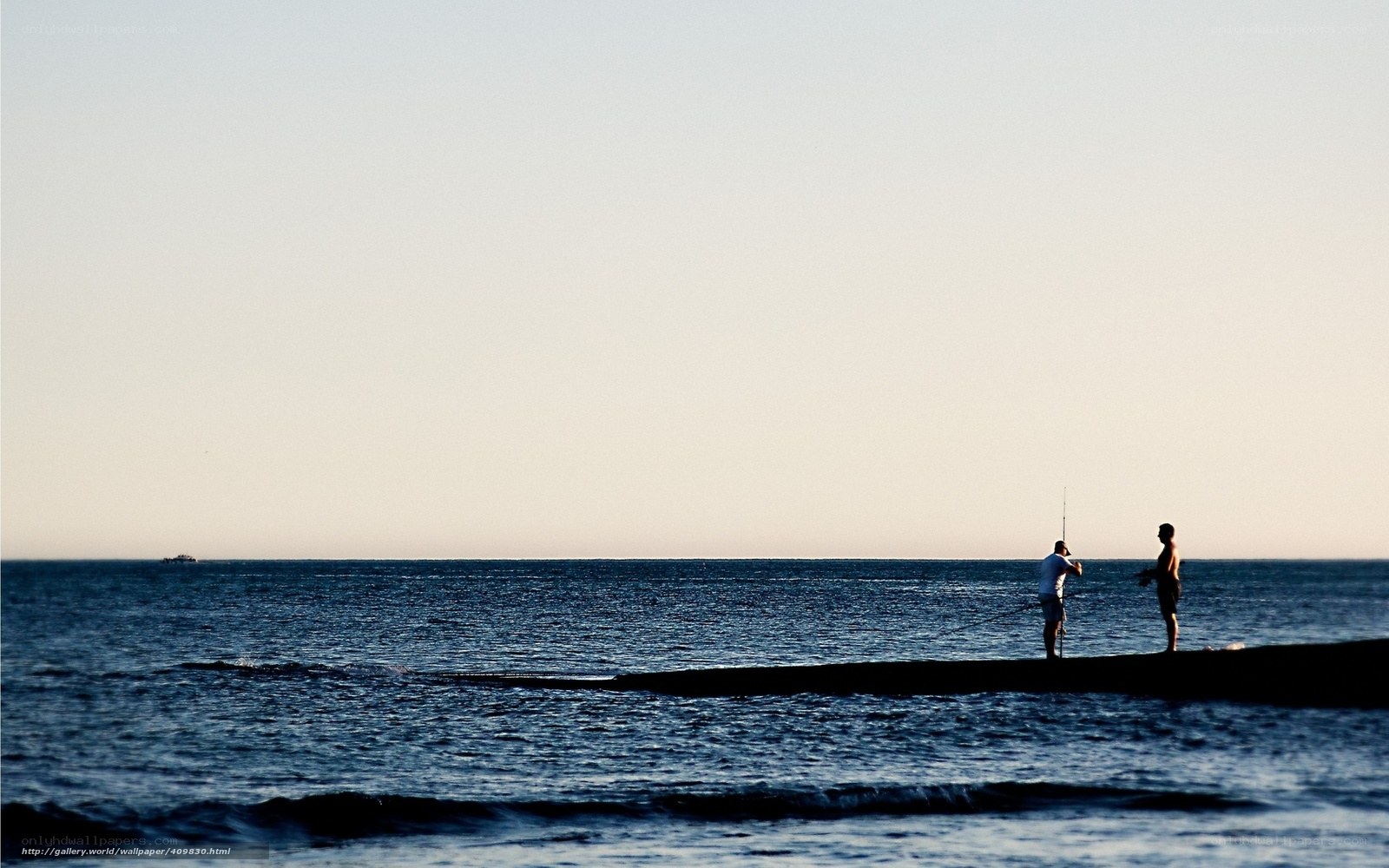 Silhouettes of fishermen at sunset