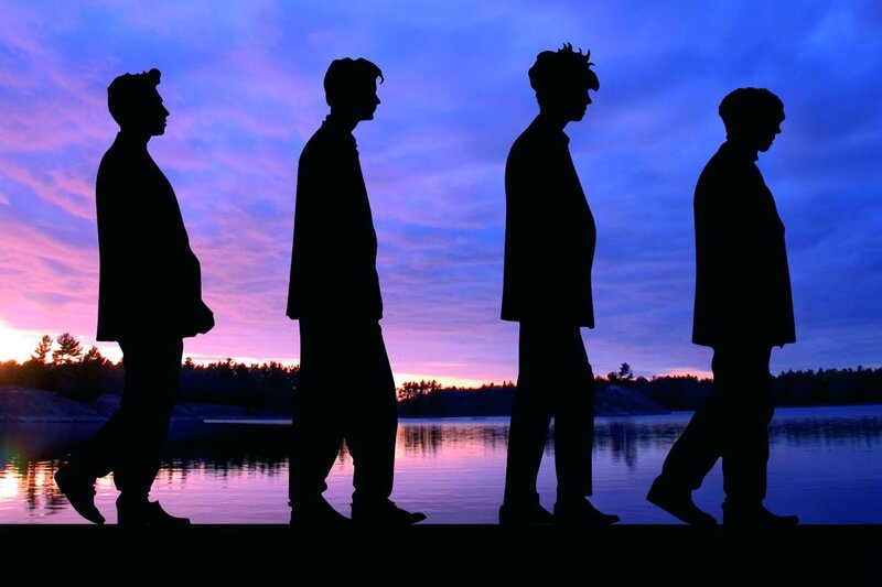 silhouettes of four men at sunset
