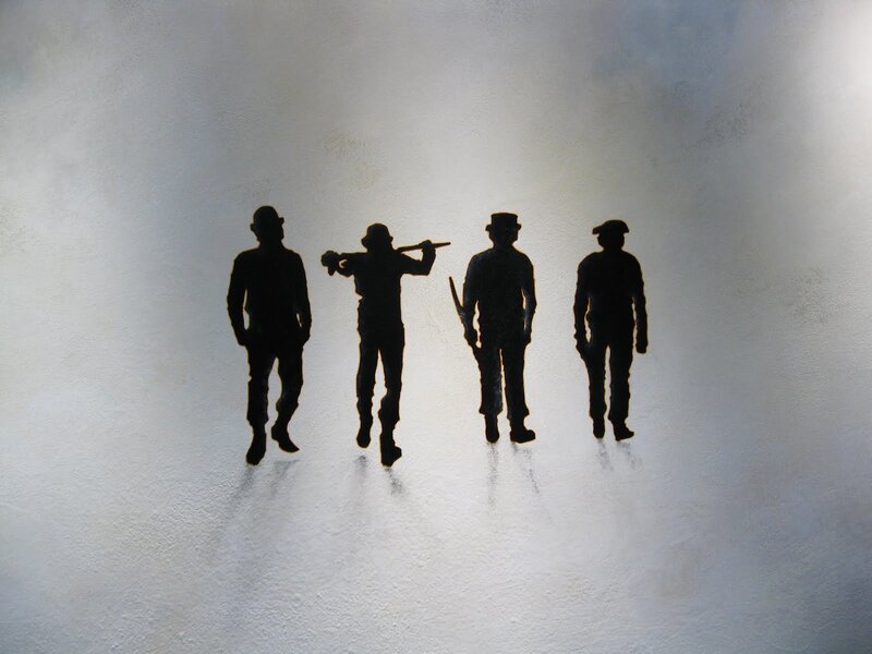 silhouettes of four men walking
