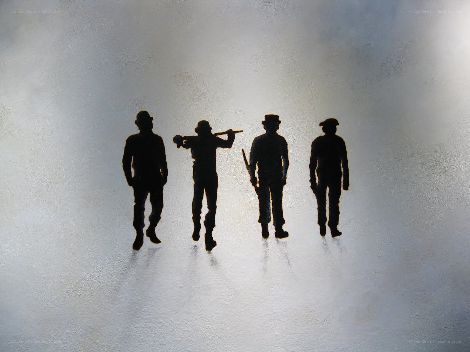 silhouettes of four men walking