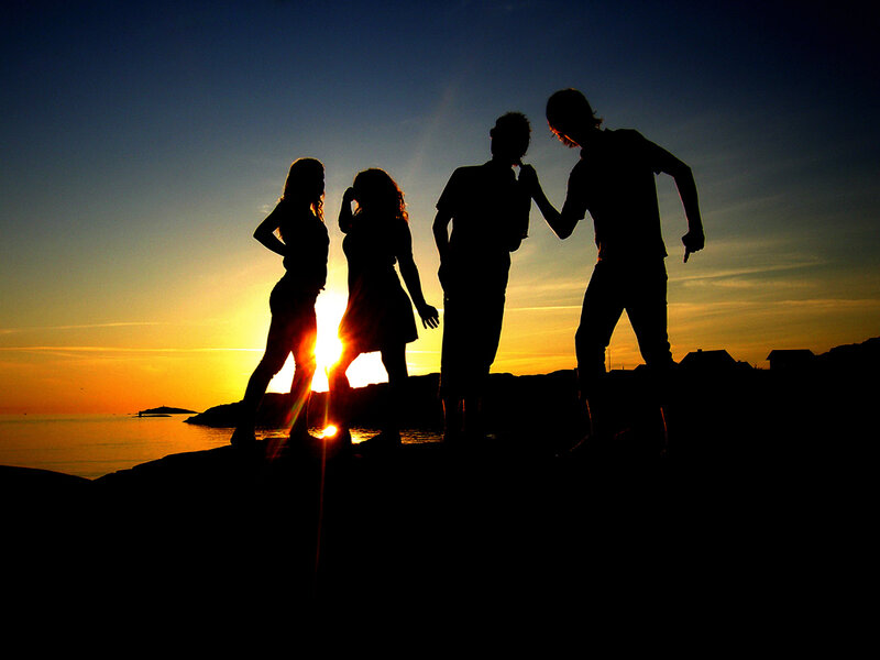 Silhouettes of friends at sunset