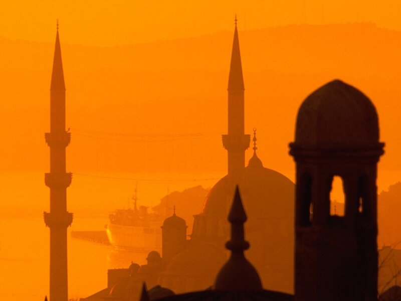 Silhouettes of mosques at sunset